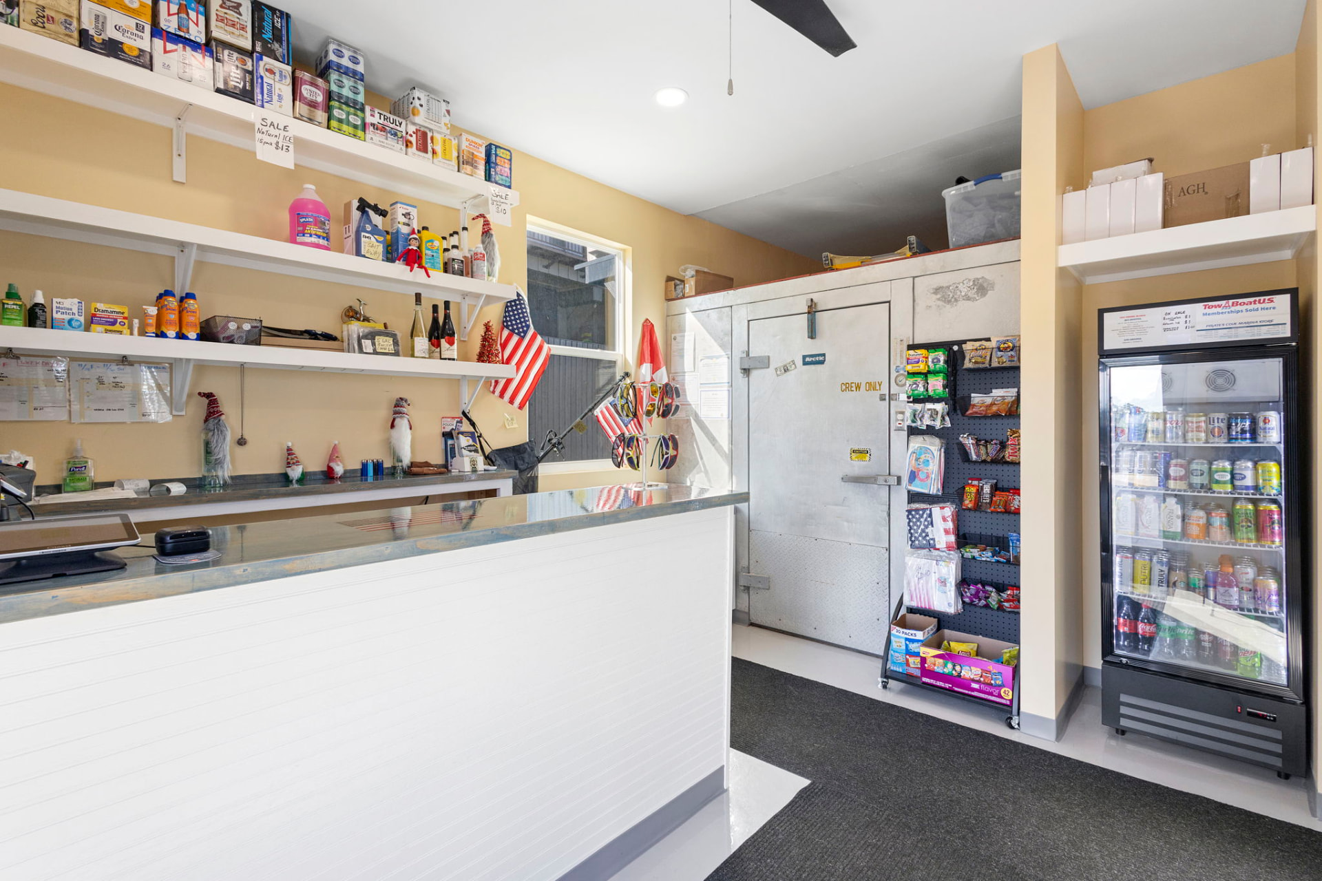 Marina store interior with counter, cooler and shelved goods