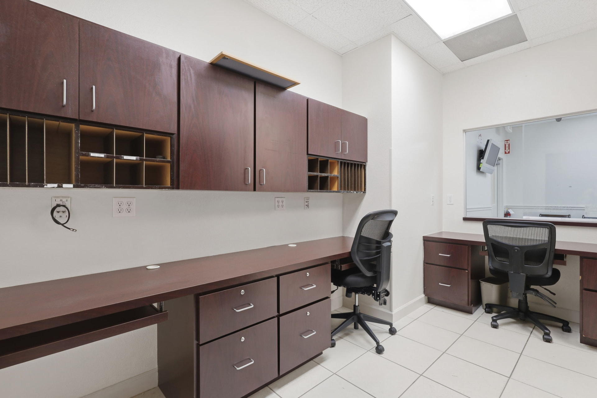 Medical office work room with built-in cabinetry and desks