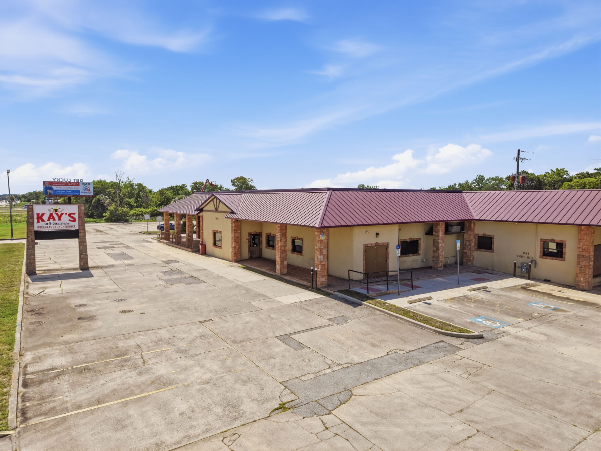 Retail restaurant building exterior with parking lot, aerial view