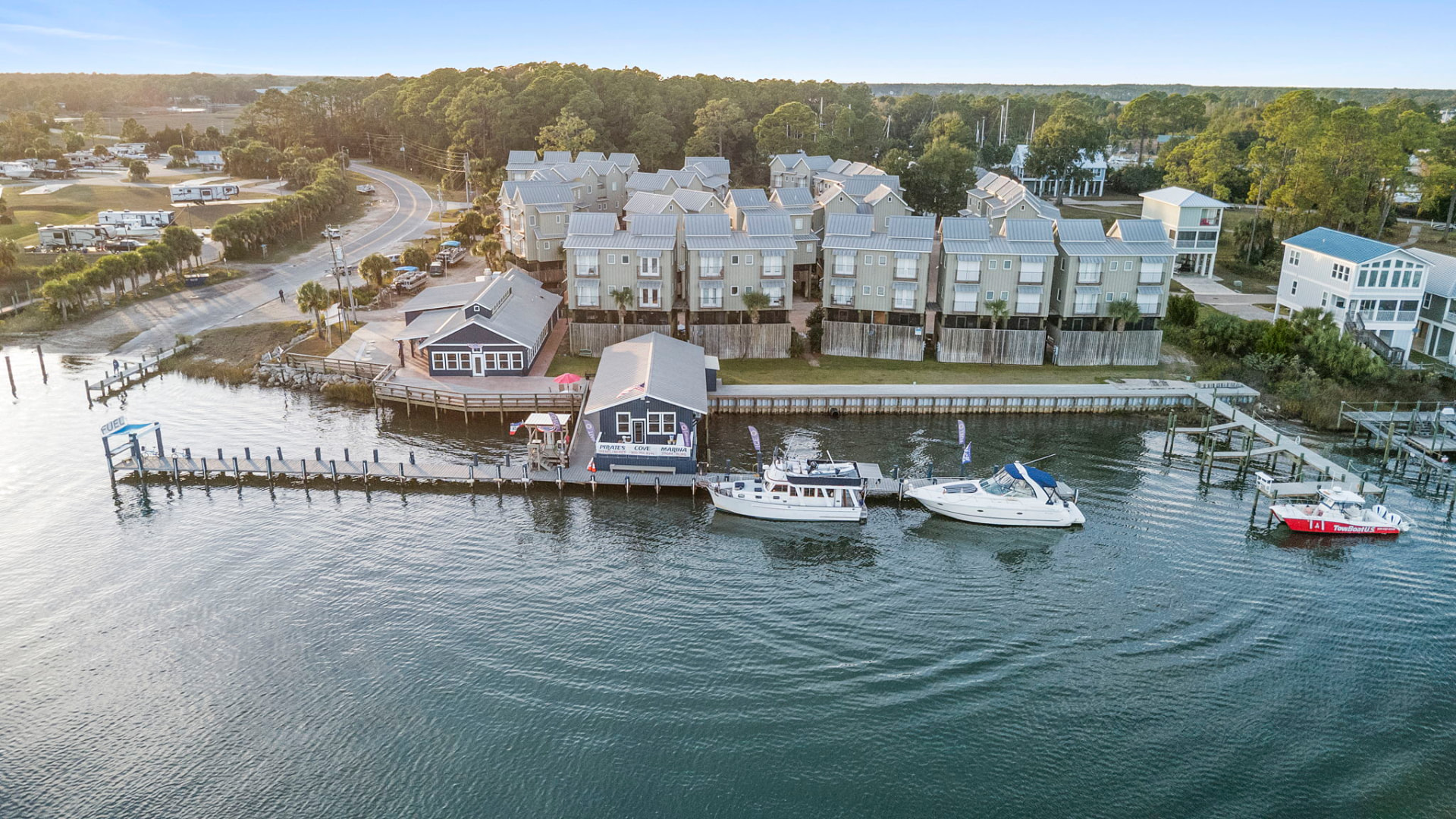 Aerial drone view of a waterfront marina and condo development
