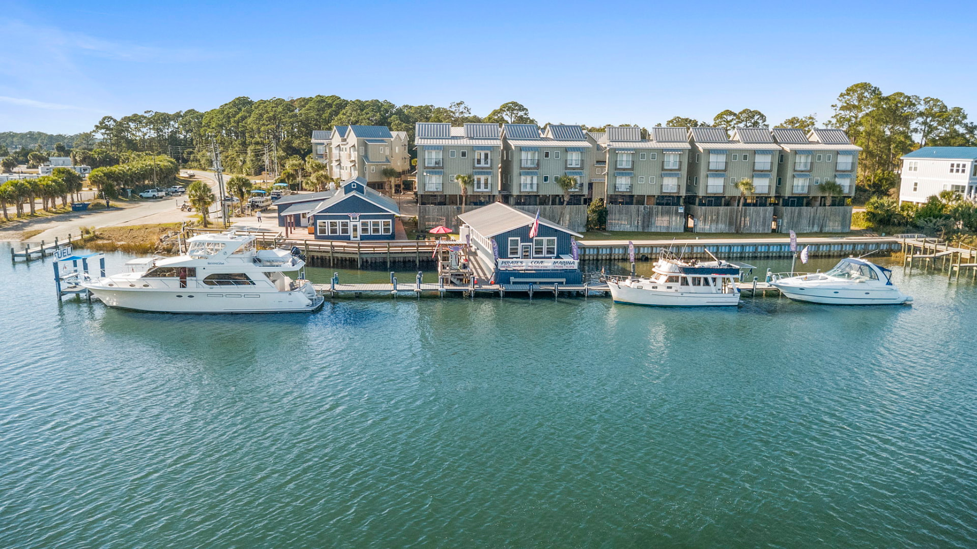 Marina with yachts docked in front of waterfront buildings