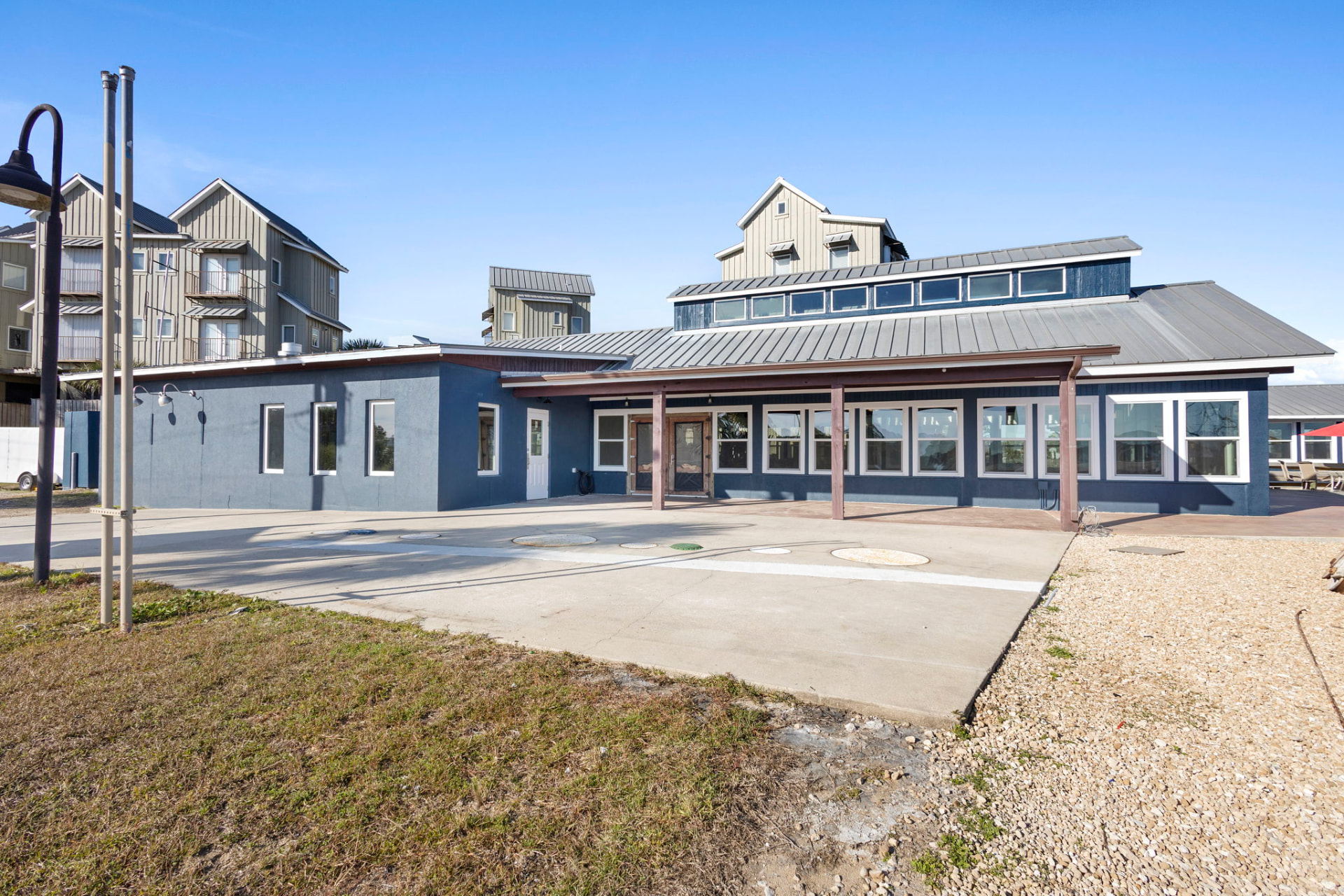 Blue commercial building exterior with covered walkway