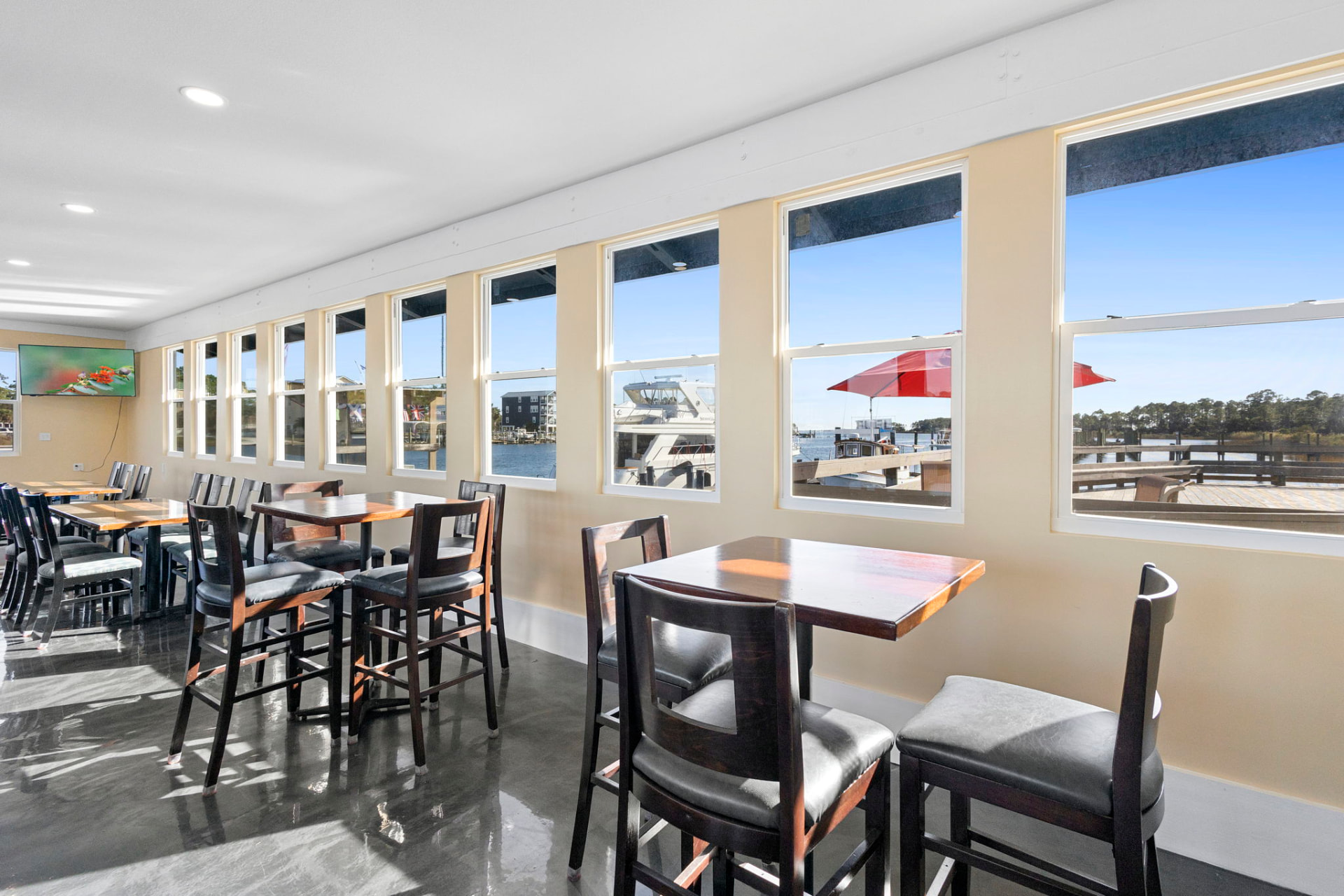 Waterfront dining room with a wall of windows over the marina